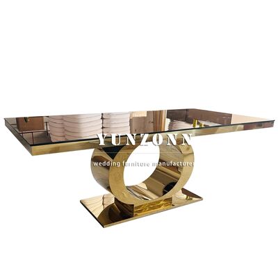 Buen precio Mesa de boda de lujo de venta superior con base redonda de acero inoxidable dorado y tapa de espejo de vidrio, mobiliario moderno para hotel en línea